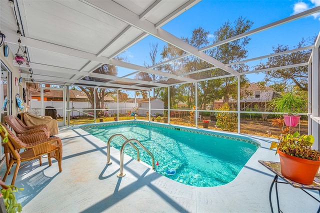 view of swimming pool with a patio, a lanai, and a storage unit