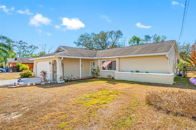 single story home with a garage and a front yard