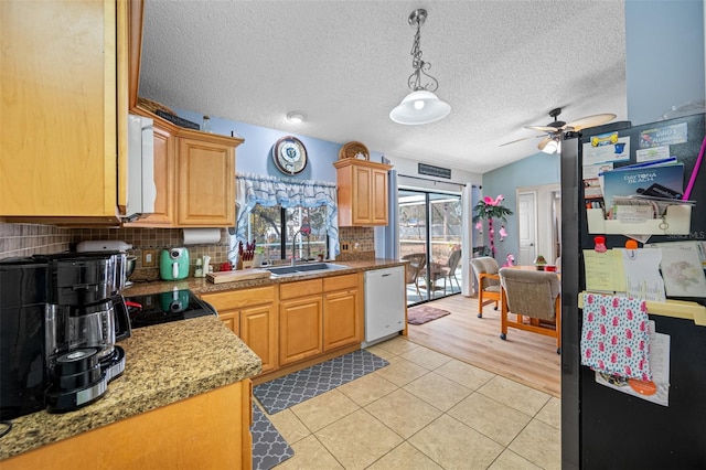 kitchen featuring tasteful backsplash, sink, hanging light fixtures, light tile patterned floors, and white dishwasher