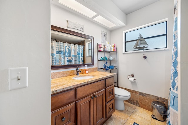 bathroom featuring vanity, tile patterned floors, and toilet