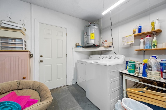 washroom with water heater and separate washer and dryer