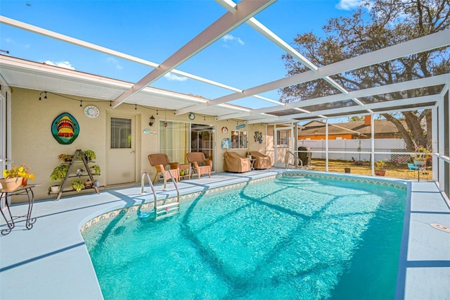 view of pool featuring glass enclosure and a patio area