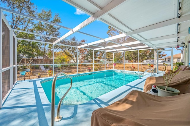 view of pool with glass enclosure