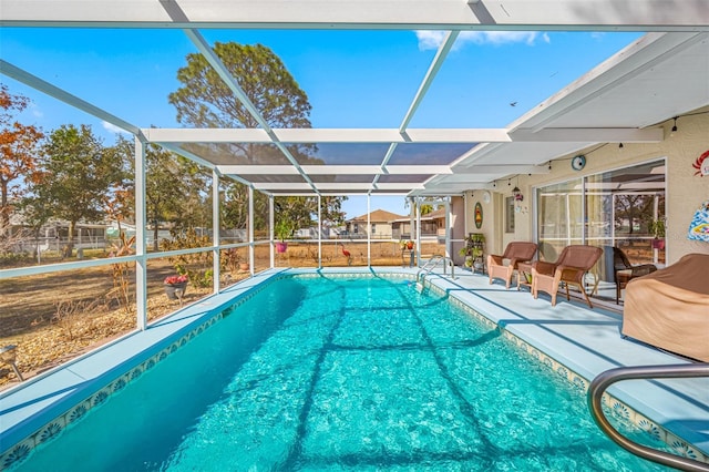 view of pool with a patio area and glass enclosure