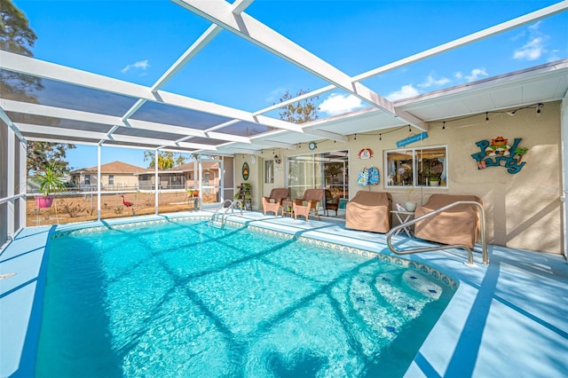 view of pool featuring a patio area and glass enclosure