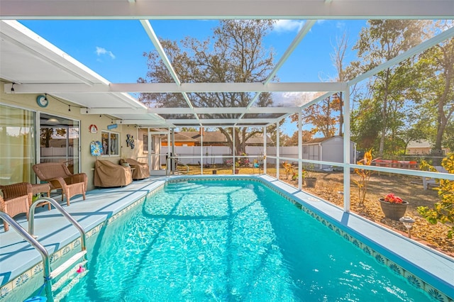 view of pool featuring a lanai and a storage shed