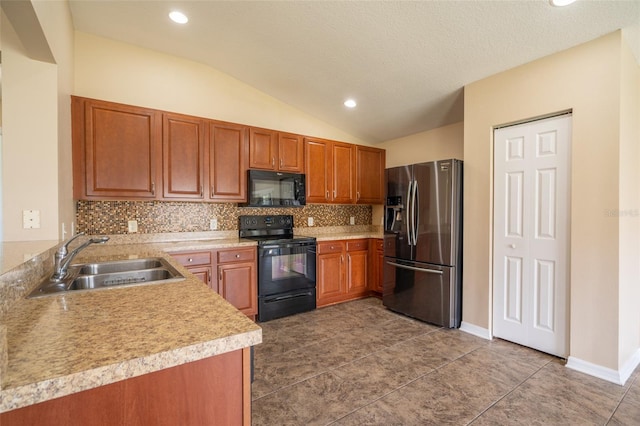 kitchen featuring tasteful backsplash, brown cabinets, a sink, and black appliances