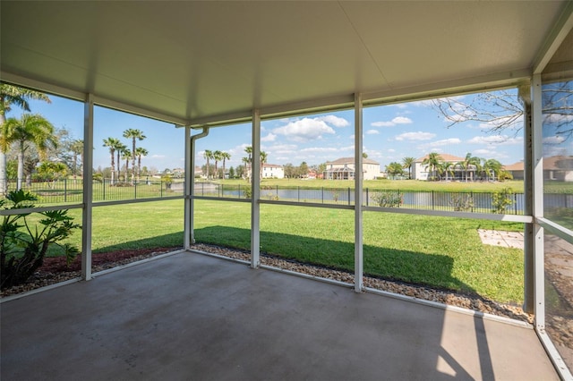 unfurnished sunroom featuring a water view