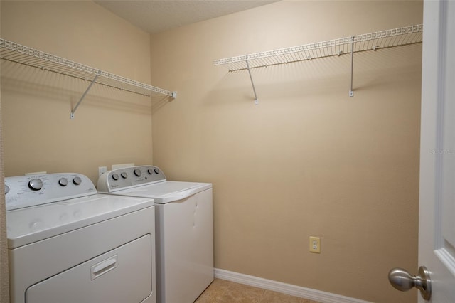 laundry area with laundry area, baseboards, and washer and dryer