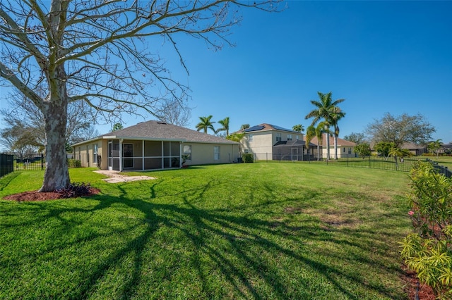 view of yard with a fenced backyard and a sunroom