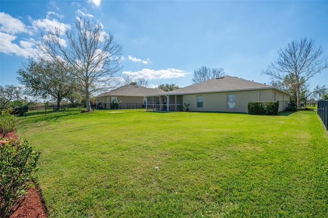 view of yard featuring a sunroom and a fenced backyard