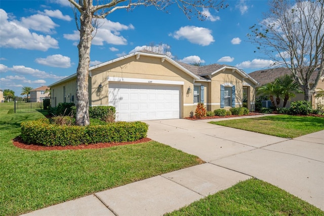 ranch-style house with stucco siding, concrete driveway, an attached garage, fence, and a front lawn