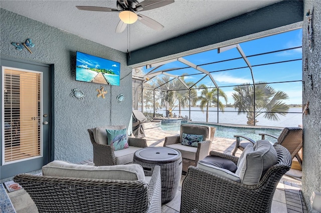 view of patio featuring a lanai, an outdoor pool, an outdoor hangout area, and a ceiling fan