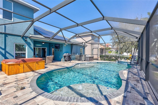 pool featuring a jacuzzi, a grill, ceiling fan, and a patio area