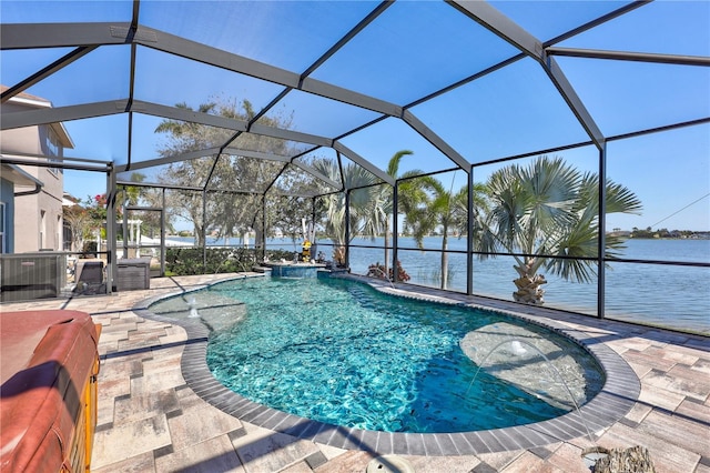 outdoor pool with glass enclosure, a water view, and a patio area