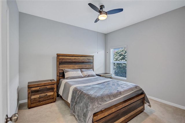 bedroom with baseboards, light carpet, and ceiling fan