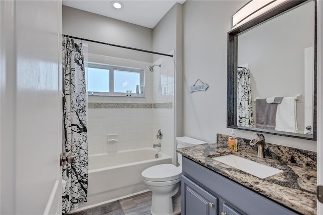 full bath featuring toilet, vanity, and shower / bath combo