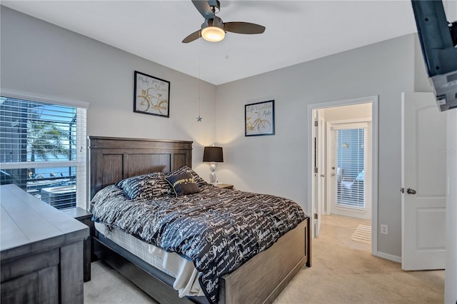 bedroom with ceiling fan, baseboards, and light carpet