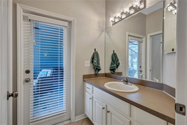 bathroom with tile patterned floors and vanity