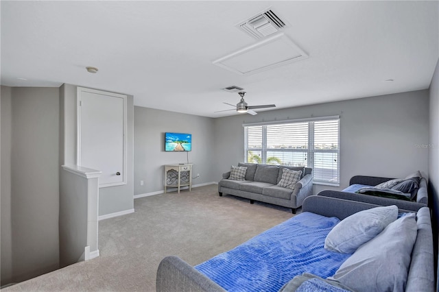 living area with visible vents, attic access, baseboards, and carpet floors