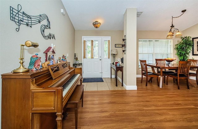 foyer entrance with lofted ceiling and light hardwood / wood-style floors