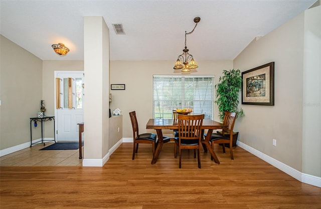 dining area featuring a chandelier and light hardwood / wood-style floors