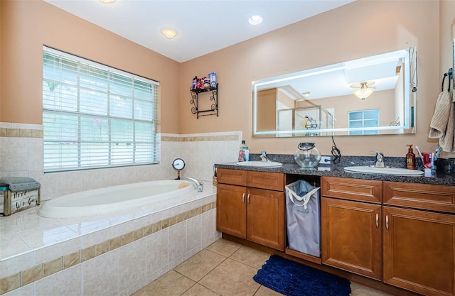 bathroom with tile patterned flooring, vanity, and independent shower and bath