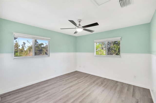 spare room featuring light hardwood / wood-style floors and ceiling fan