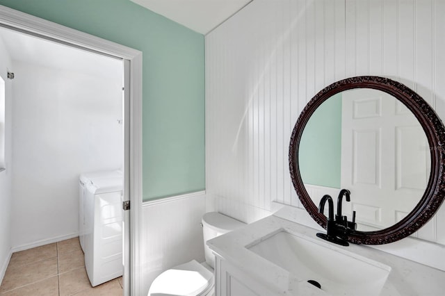 bathroom with washer / clothes dryer, vanity, tile patterned floors, and toilet