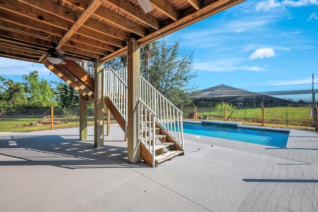 view of swimming pool with a patio and ceiling fan