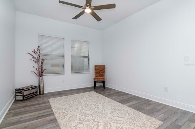 living area featuring dark hardwood / wood-style floors and ceiling fan