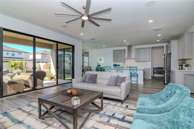 living room with sink and light hardwood / wood-style flooring