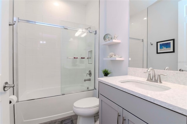 full bathroom with vanity, shower / bath combination with glass door, and toilet