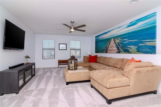 carpeted living room with ceiling fan