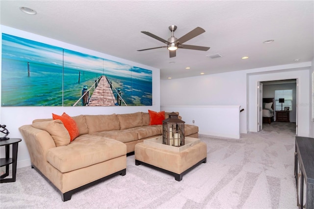 carpeted living room with ceiling fan