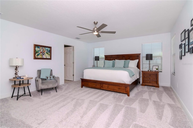 bedroom featuring light carpet and ceiling fan