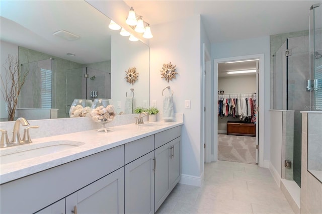 bathroom with vanity, tile patterned flooring, and a shower with door