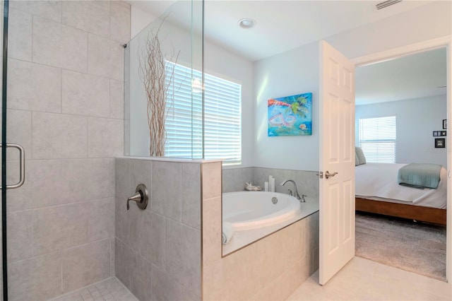 bathroom featuring tile patterned floors and separate shower and tub