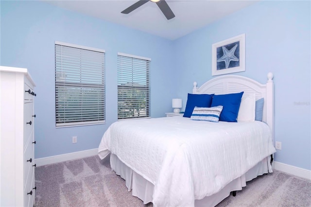 bedroom featuring light colored carpet and ceiling fan