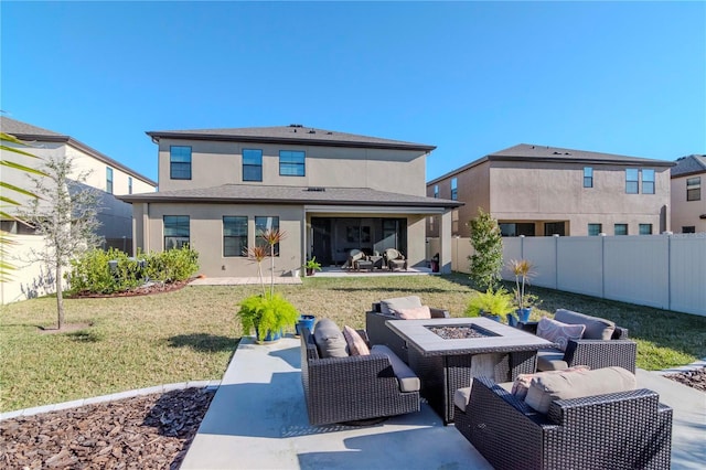 rear view of house with a yard, an outdoor living space with a fire pit, and a patio