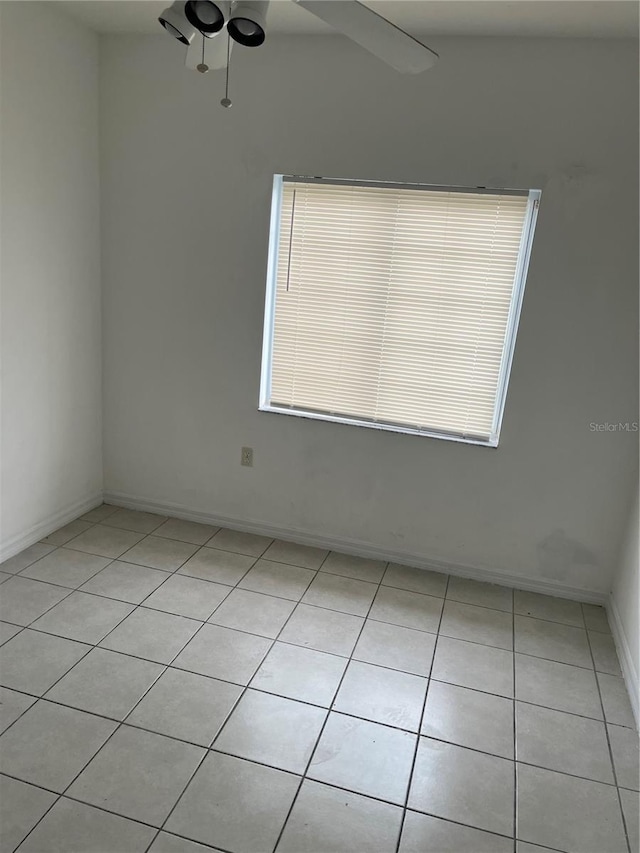 unfurnished room featuring ceiling fan and light tile patterned floors