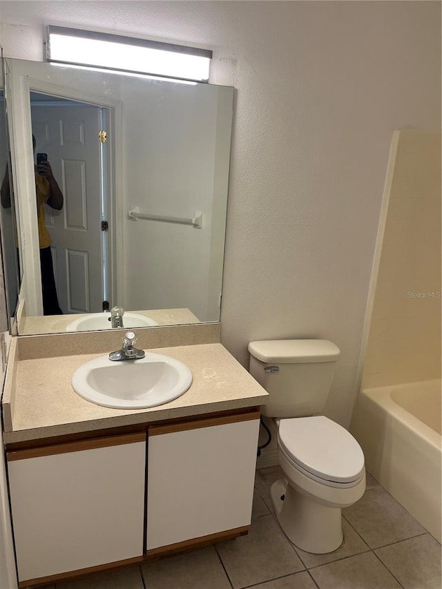 bathroom featuring tile patterned floors, toilet, and vanity