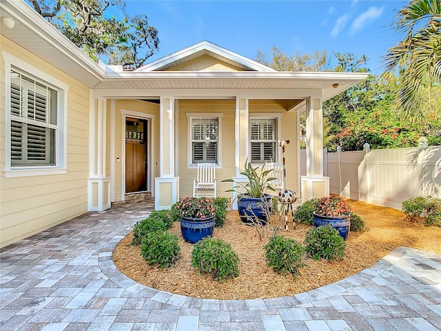 view of exterior entry featuring a porch