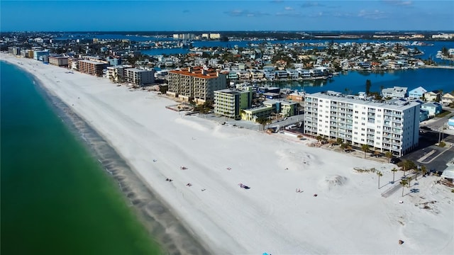 birds eye view of property with a water view and a view of the beach