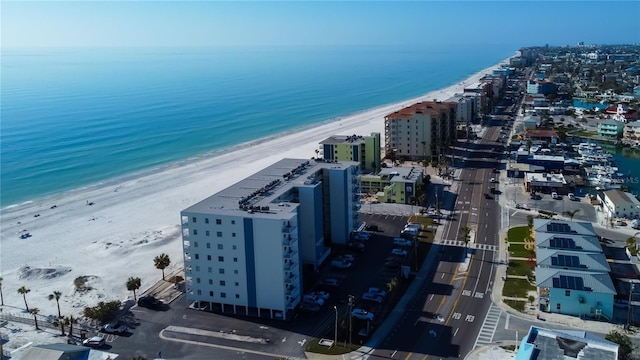 drone / aerial view with a water view and a beach view