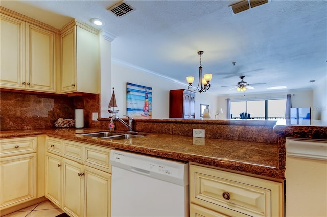 kitchen featuring sink, crown molding, dishwasher, backsplash, and cream cabinetry