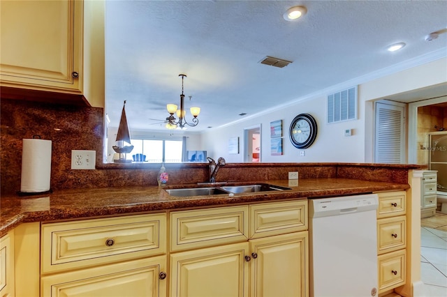 kitchen with sink, crown molding, white dishwasher, decorative light fixtures, and cream cabinetry