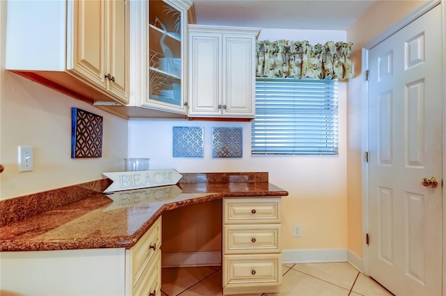 office area with built in desk and light tile patterned flooring