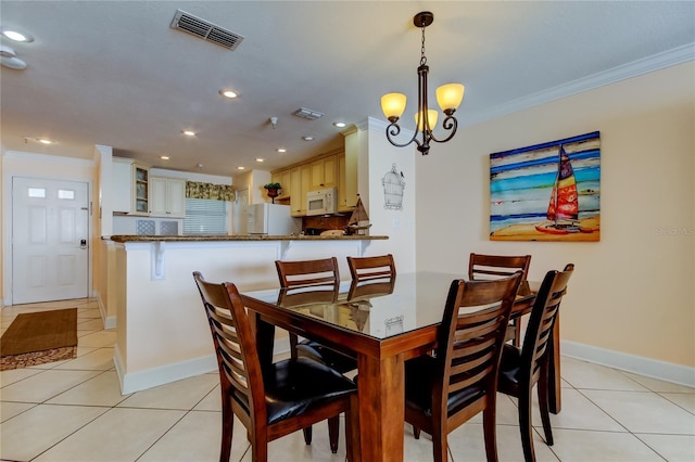 tiled dining area with crown molding and a notable chandelier