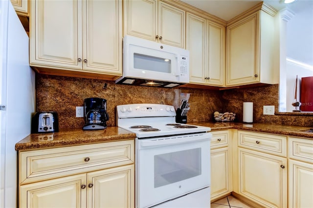 kitchen featuring cream cabinets, white appliances, and decorative backsplash